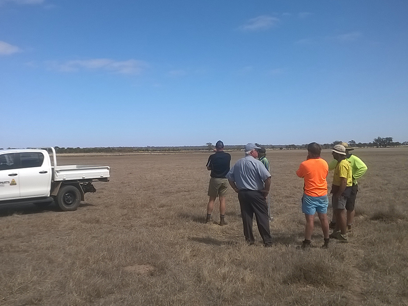 Inspecting the proposed Harris trial site, sloping down to the flats.